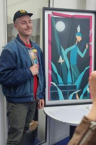 OJI devant l'affiche 2022 des Lézarts